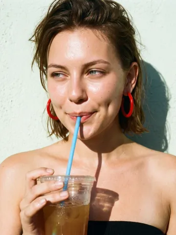Nora sipping an iced drink through a straw, UGC drink ad